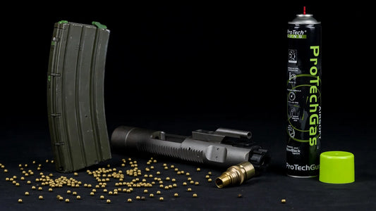WE M4 RIS GBBR 500-round torture test: green gas magazine, bolt carrier group and BBs in a studio still life