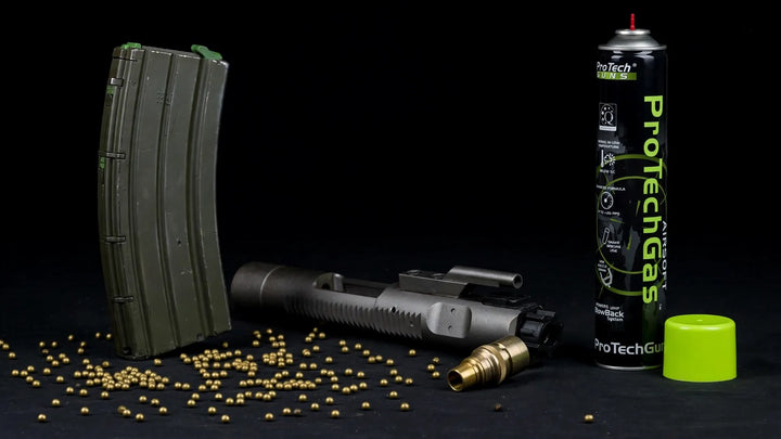 WE M4 RIS GBBR 500-round torture test: green gas magazine, bolt carrier group and BBs in a studio still life