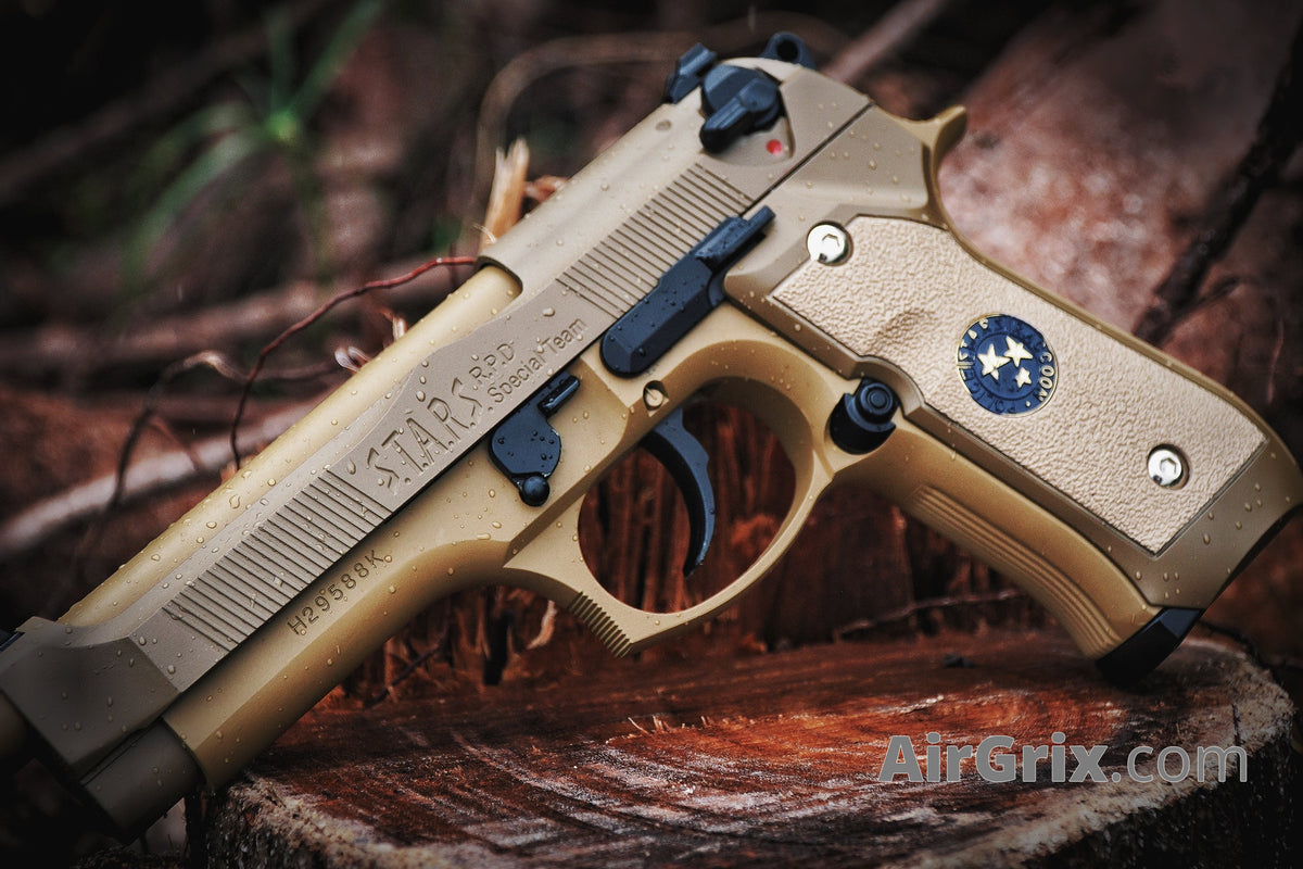 WE M9 Biohazard 20th Anniversary Tan GBB Pistol, outdoor lifestyle shot on a wooden stump with water droplets on the slide