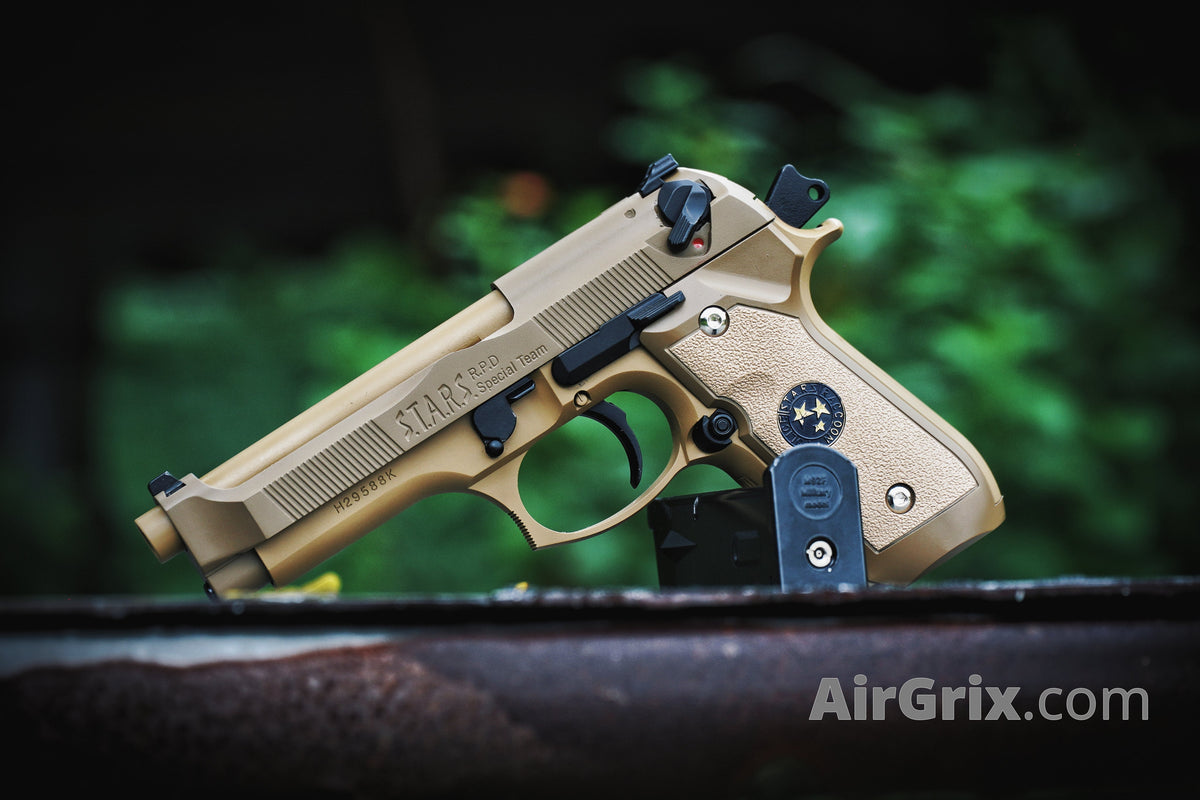 WE M9 Biohazard 20th Anniversary Tan GBB Pistol, left side view outdoors with magazine seated behind the grip